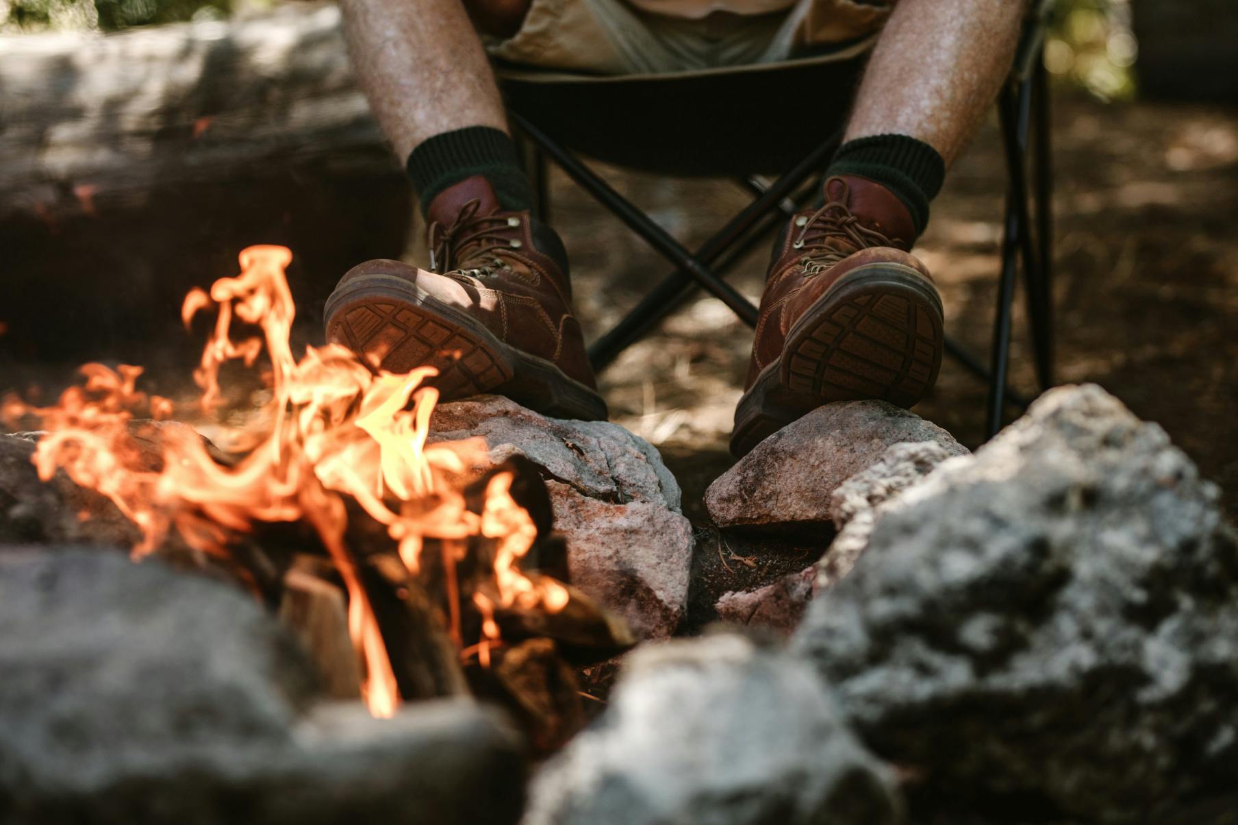 Boots resting on rocks by a campfire - Engage with First Nations stories in the Larapinta region