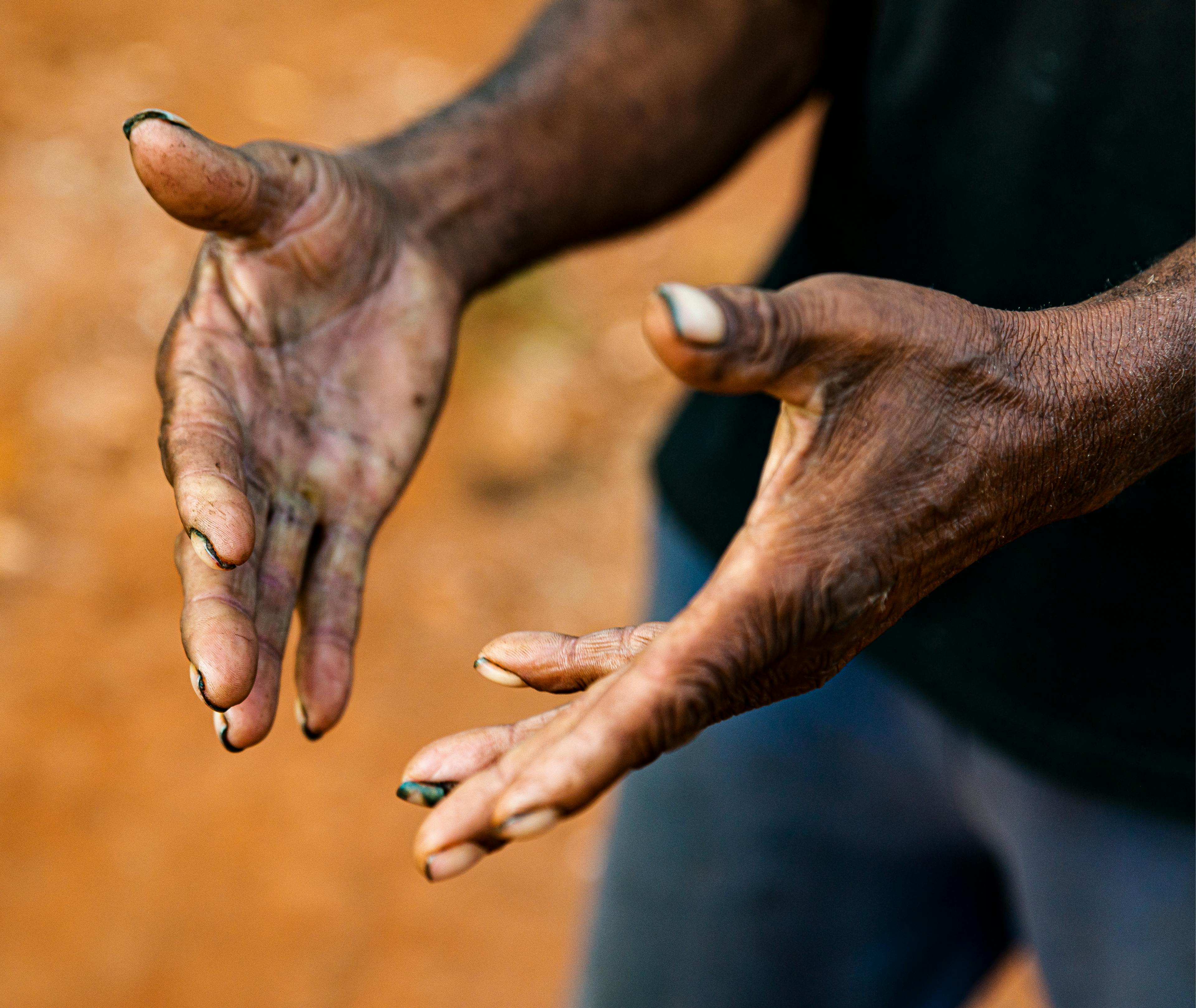 Person gesturing openly with hands - learn about first nations history with a unqiue experience on the Larapinta trail