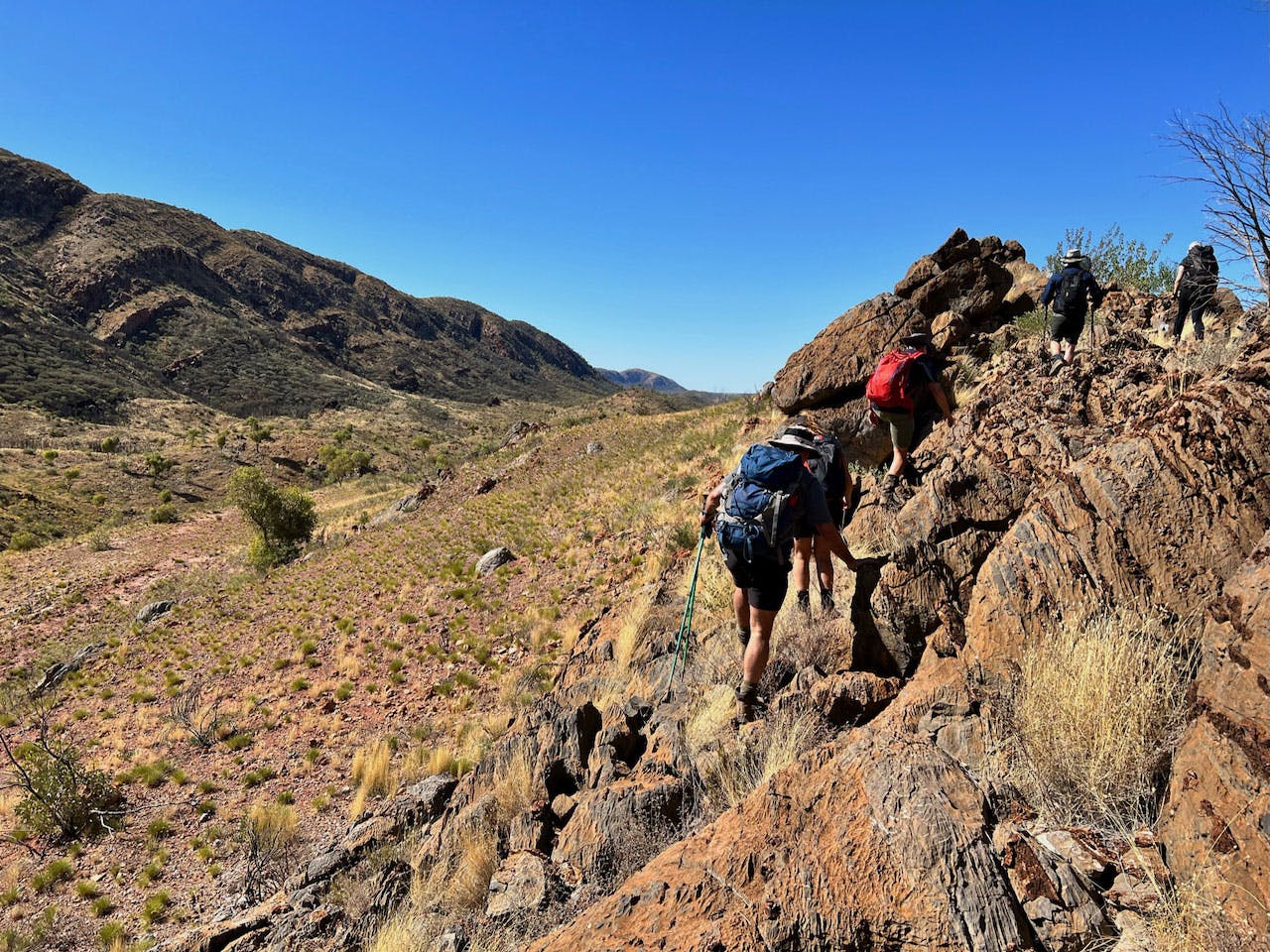 Group hiking along a trail - develop as a leadership team with Larapinta Connect
